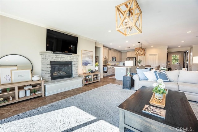 tiled living area featuring a stone fireplace, recessed lighting, a notable chandelier, and crown molding
