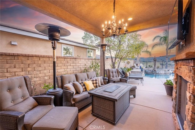 view of patio / terrace with an outdoor hangout area, a pool with connected hot tub, and a fenced backyard