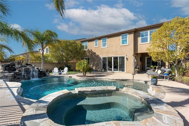 view of pool featuring fence, a pool with connected hot tub, and a patio