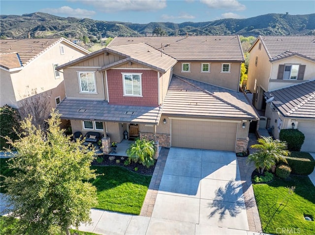 22514 Brightwood Pl, Saugus, CA 91350 - view of front facade with concrete driveway, a mountain view, stone siding, and stucco siding