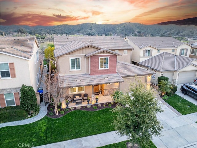 22514 Brightwood Pl, Saugus, CA 91350 - view of front of house featuring outdoor lounge area, a mountain view, concrete driveway, stucco siding, and a front yard