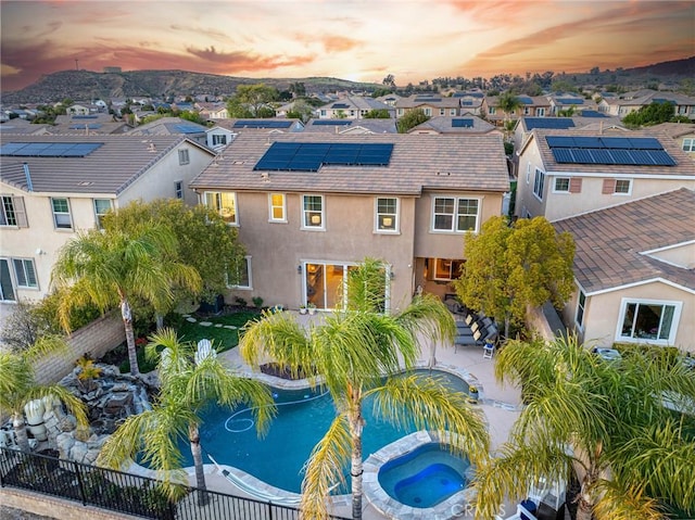 aerial view at dusk featuring a residential view