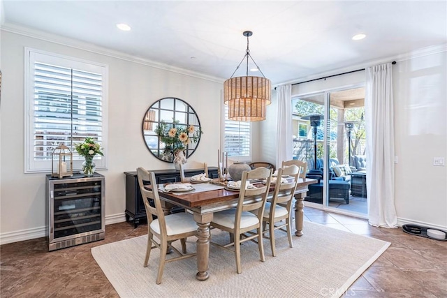 dining space with baseboards, ornamental molding, wine cooler, and recessed lighting