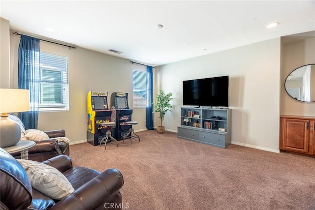 carpeted living area featuring baseboards, visible vents, and recessed lighting