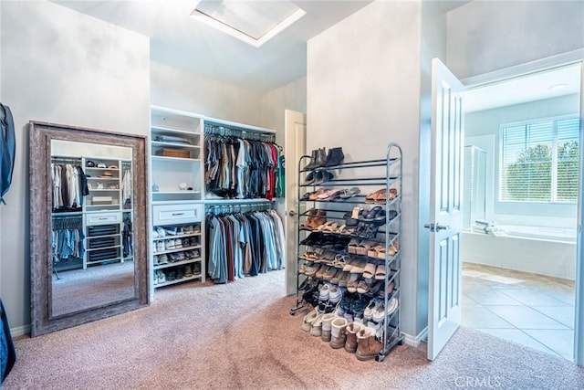 walk in closet with attic access and carpet floors