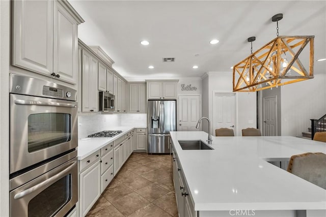 22514 Brightwood Pl, Saugus, CA 91350 - kitchen with stainless steel appliances, a chandelier, ornamental molding, recessed lighting, and light countertops