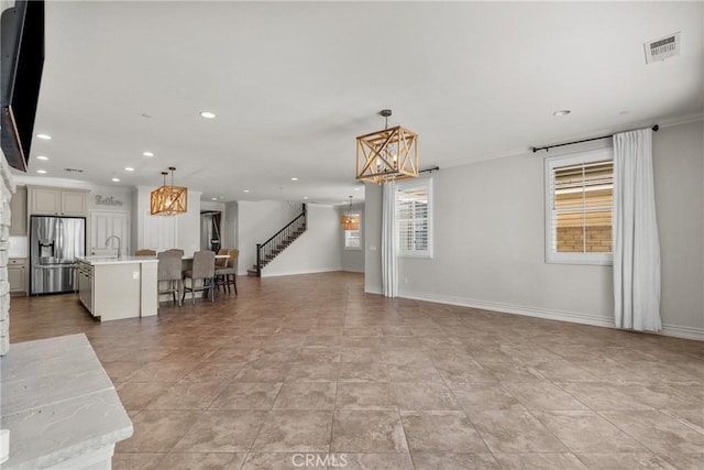 22514 Brightwood Pl, Saugus, CA 91350 - living area with a chandelier, recessed lighting, stairs, and crown molding