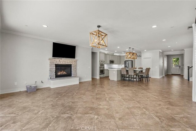 22514 Brightwood Pl, Saugus, CA 91350 - living room featuring recessed lighting, ornamental molding, and a stone fireplace
