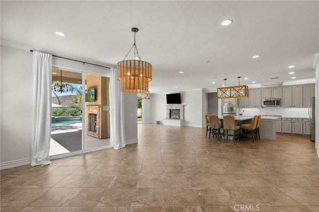 22514 Brightwood Pl, Saugus, CA 91350 - dining area featuring a stone fireplace, recessed lighting, and a chandelier
