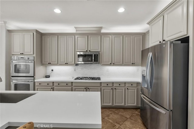 22514 Brightwood Pl, Saugus, CA 91350 - kitchen featuring appliances with stainless steel finishes, backsplash, light countertops, gray cabinets, and recessed lighting