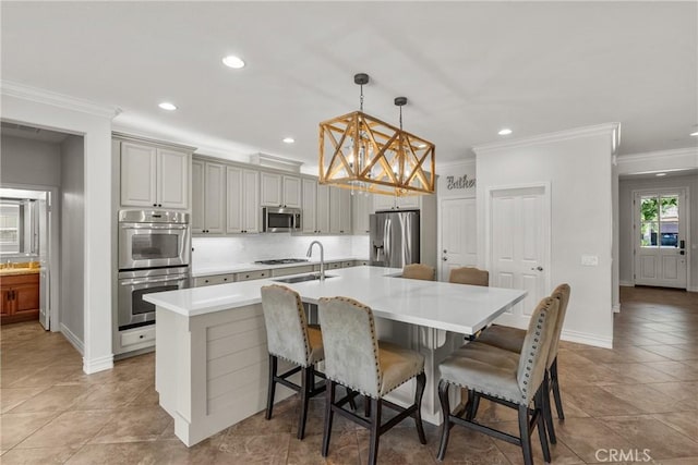 22514 Brightwood Pl, Saugus, CA 91350 - kitchen with stainless steel appliances, a chandelier, ornamental molding, an island with sink, and a breakfast bar