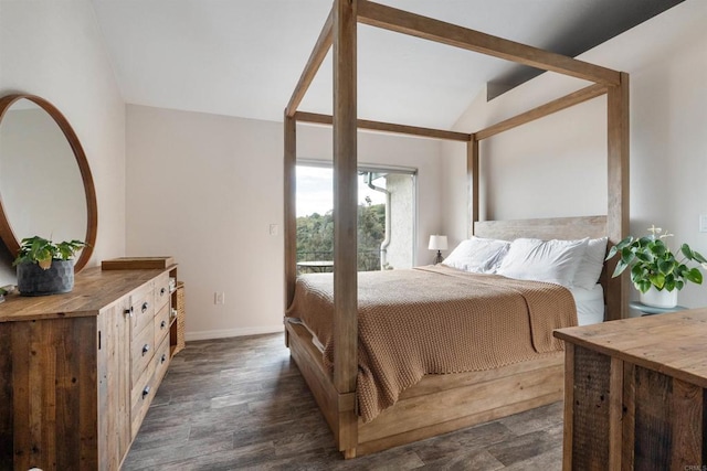 bedroom with vaulted ceiling, dark wood-type flooring, and baseboards