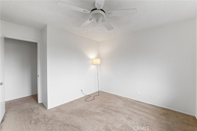 spare room featuring carpet floors and ceiling fan