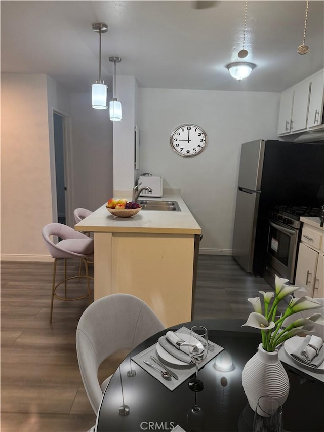 4727 W 147th St Unit 116, Lawndale, CA 90260 - kitchen featuring stainless steel gas stove, a sink, baseboards, dark wood-style floors, and light countertops
