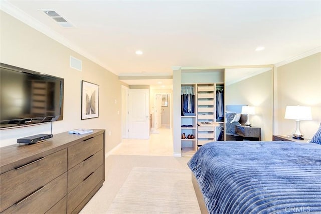 bedroom with recessed lighting, visible vents, ornamental molding, a closet, and light colored carpet