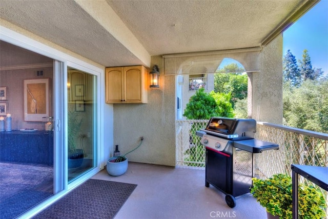 view of patio featuring a grill and a balcony