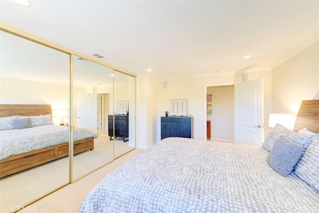 bedroom featuring crown molding, a closet, carpet floors, visible vents, and recessed lighting