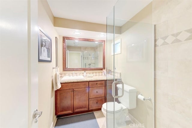 full bathroom with toilet, walk in shower, vanity, and baseboards