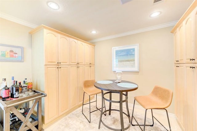 dining room featuring baseboards, ornamental molding, and recessed lighting