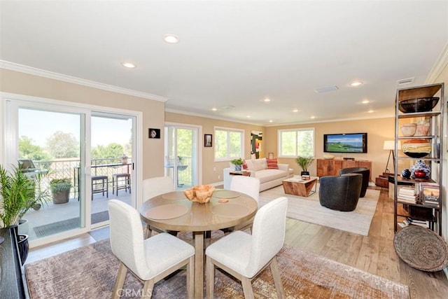 dining area featuring crown molding, light wood-style floors, visible vents, and recessed lighting