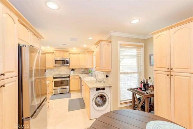 kitchen with tasteful backsplash, a sink, light brown cabinetry, stainless steel appliances, and washer / clothes dryer