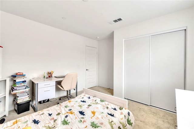 bedroom with light carpet, visible vents, and a closet
