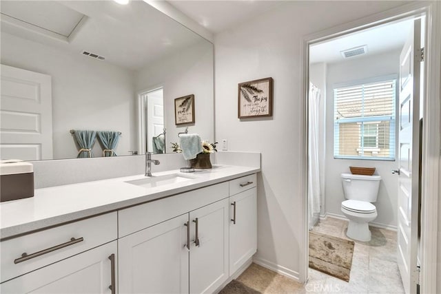 full bath with baseboards, visible vents, vanity, and toilet