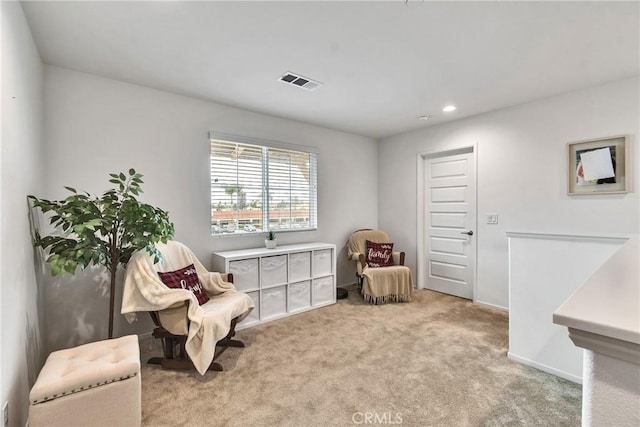 living area featuring baseboards, recessed lighting, visible vents, and carpet