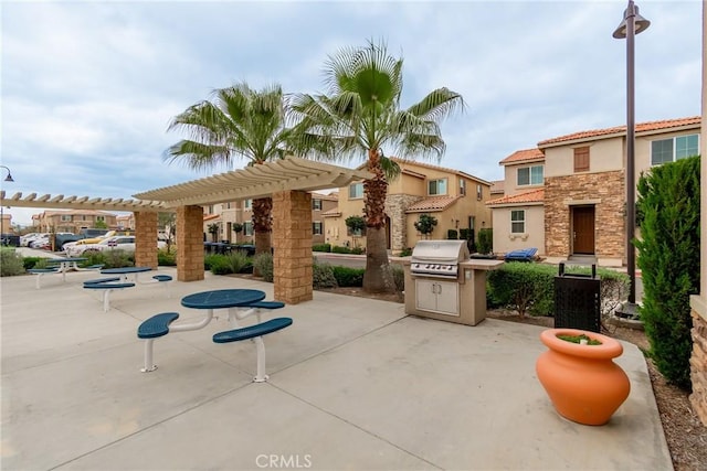 exterior space with a pergola and a grill