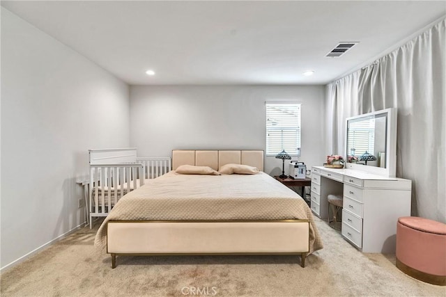 bedroom featuring light carpet, visible vents, and recessed lighting