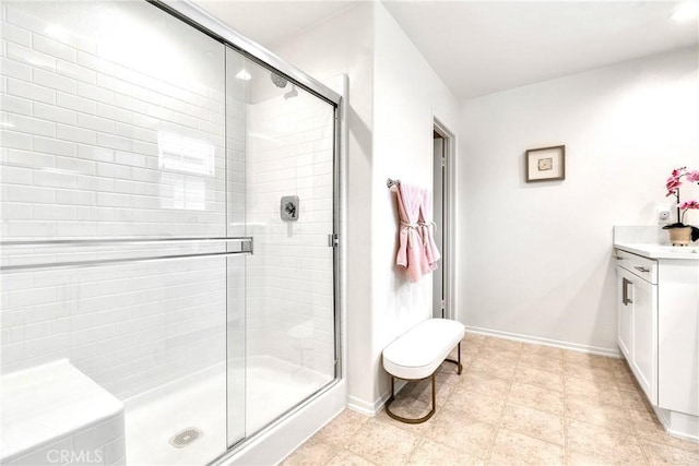 full bathroom with vanity, baseboards, and a shower stall