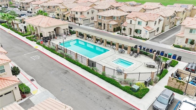 pool with a residential view and fence
