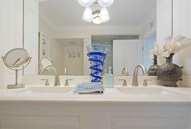 bathroom featuring visible vents, a sink, and double vanity