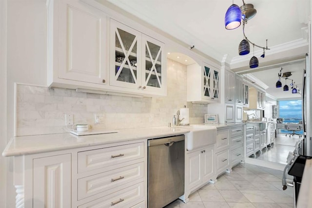 kitchen with stainless steel appliances, a sink, white cabinetry, decorative backsplash, and light countertops