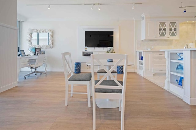 dining space featuring rail lighting and light wood-style floors