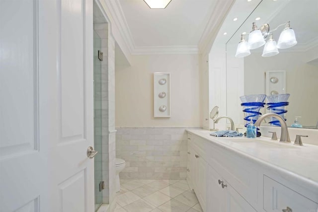 bathroom featuring toilet, tile patterned flooring, a shower stall, crown molding, and vanity