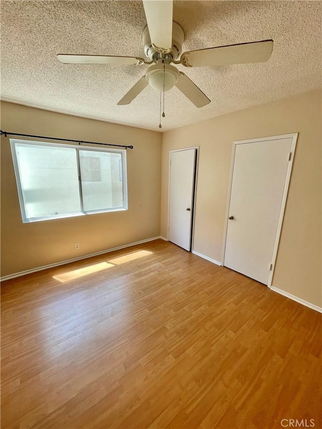 341 N Isabel St, Glendale, CA 91206 - empty room featuring light wood-style flooring, a textured ceiling, a ceiling fan, and baseboards