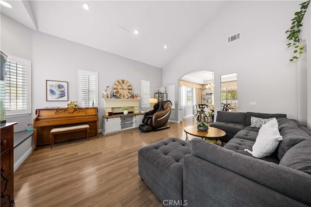 24288 Highcrest Dr, Diamond Bar, CA 91765 - living area with visible vents, arched walkways, light wood-style floors, a wealth of natural light, and high vaulted ceiling