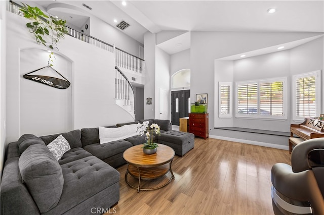 24288 Highcrest Dr, Diamond Bar, CA 91765 - living room featuring high vaulted ceiling, stairs, visible vents, and light wood-style floors