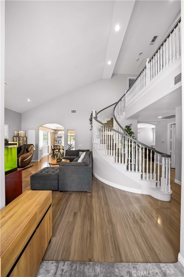 24288 Highcrest Dr, Diamond Bar, CA 91765 - living area with high vaulted ceiling, wood finished floors, visible vents, and stairs