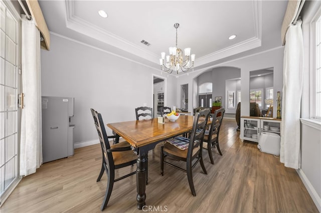 24288 Highcrest Dr, Diamond Bar, CA 91765 - dining area featuring arched walkways, a notable chandelier, visible vents, and a raised ceiling