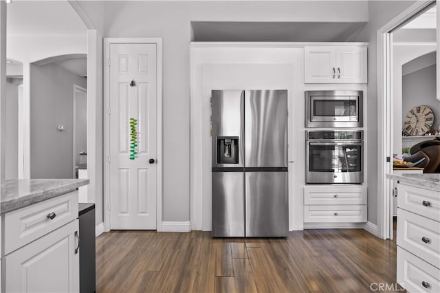 24288 Highcrest Dr, Diamond Bar, CA 91765 - kitchen with stainless steel appliances, dark wood-type flooring, arched walkways, light stone countertops, and white cabinetry