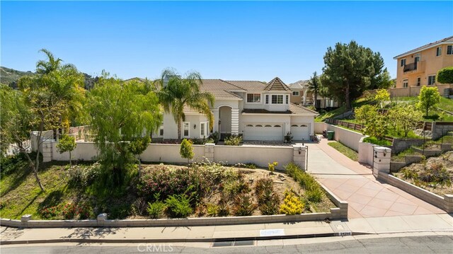 24288 Highcrest Dr, Diamond Bar, CA 91765 - view of front of property featuring concrete driveway, a tiled roof, an attached garage, fence, and stucco siding