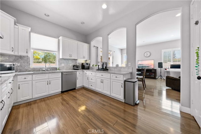 24288 Highcrest Dr, Diamond Bar, CA 91765 - kitchen with arched walkways, wood finished floors, stainless steel dishwasher, and a sink