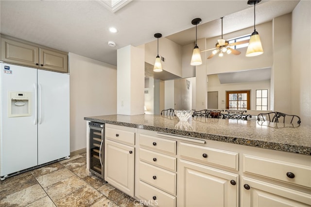 46375 Ryway Pl Unit 2, Palm Desert, CA 92260 - kitchen with a ceiling fan, wine cooler, white refrigerator with ice dispenser, and hanging light fixtures
