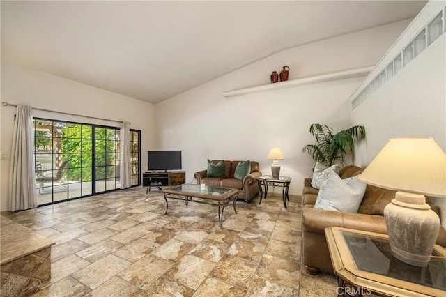 46375 Ryway Pl Unit 2, Palm Desert, CA 92260 - living room featuring vaulted ceiling and stone tile floors