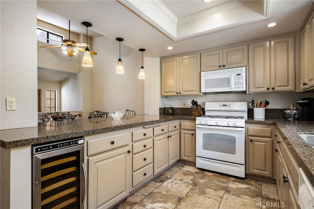 46375 Ryway Pl Unit 2, Palm Desert, CA 92260 - kitchen with crown molding, ceiling fan, white appliances, beverage cooler, and a tray ceiling