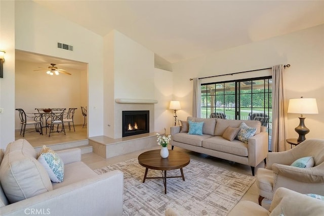 46375 Ryway Pl Unit 2, Palm Desert, CA 92260 - tiled living area featuring a tiled fireplace and ceiling fan