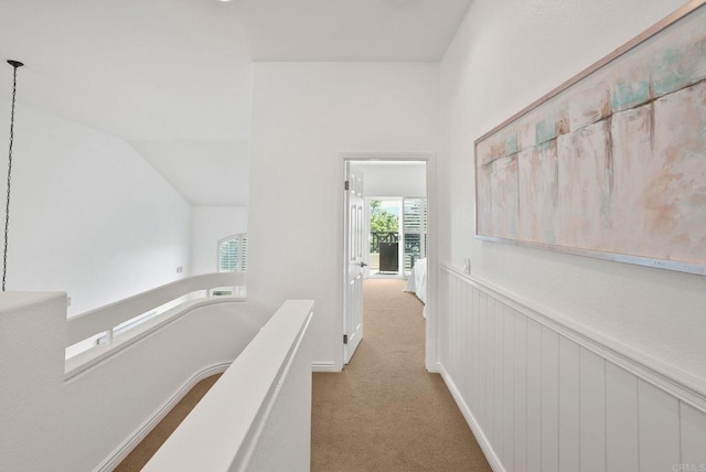 hall with carpet and an upstairs landing