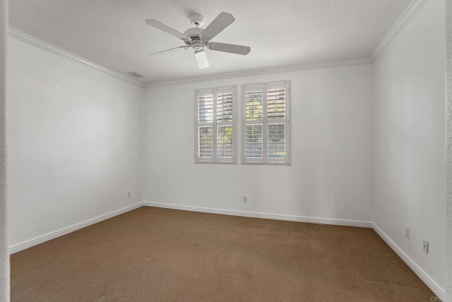 spare room with crown molding, carpet flooring, baseboards, and a ceiling fan